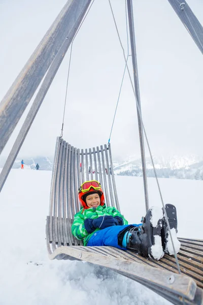 Boy sitting in sun lounger and resting — Stock Photo, Image