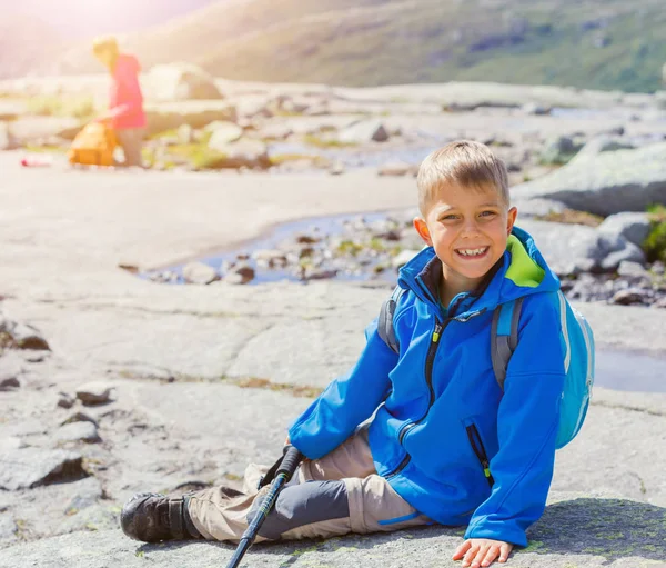 Cute boy with hiking equipment in the mountains — Stock Photo, Image