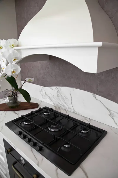 Interior of modern kitchen, oven hood and stove