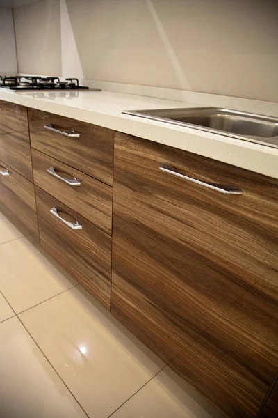 Interior of luxurious modern kitchen and walnut cabinets — Stock Photo, Image