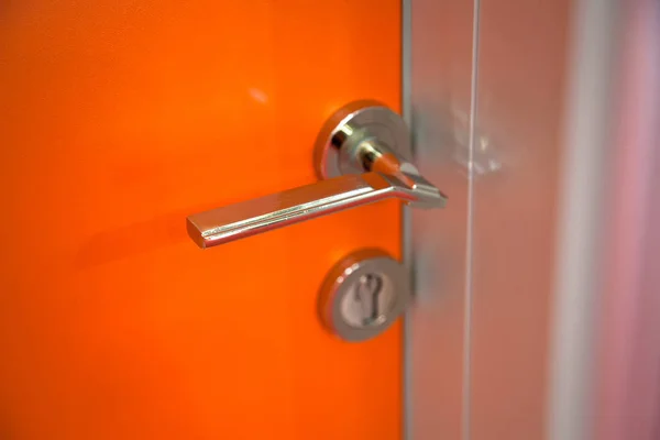 Modern orange steel door, security lock system — Stockfoto