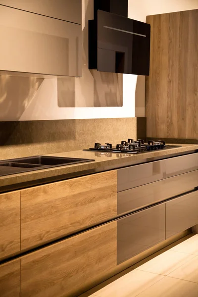 Interior of luxurious modern kitchen equipment, grey and oak cabinets