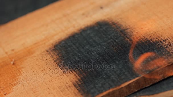 Home decorator burning wood planks — Stock Video