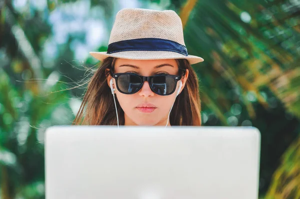 Freelancer νεαρή γυναίκα που εργάζεται σε φορητό υπολογιστή στην παραλία. Δουλειά freelance — Φωτογραφία Αρχείου