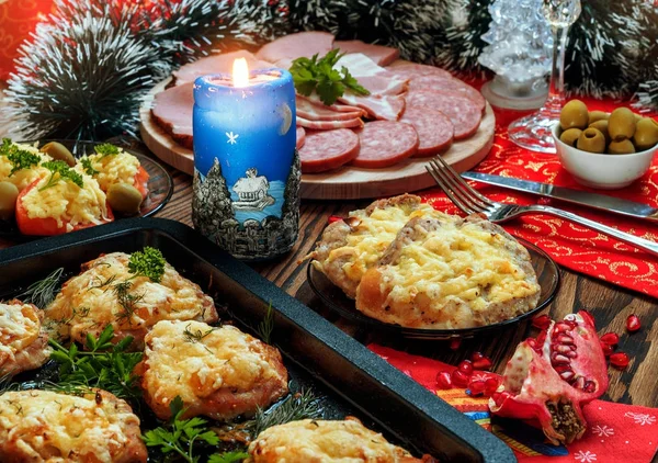 Christmas baked chops with cheese and cold cuts platter, served on the old wooden table — Stock Photo, Image