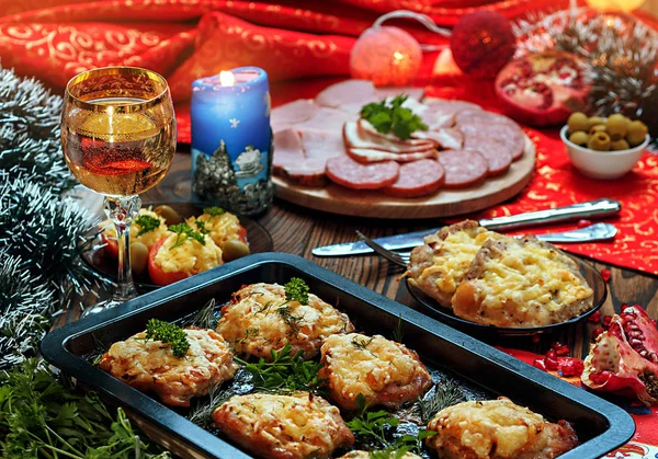 Christmas baked chops with cheese and cold cuts platter, served on the old wooden table — Stock Photo, Image