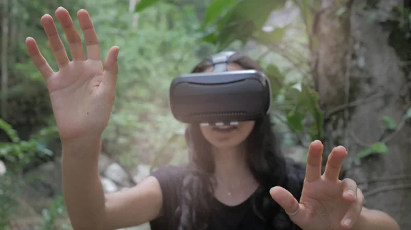 Beautiful young brunette woman use virtual reality glasses — Stock Photo, Image