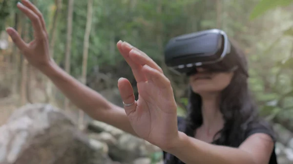 Beautiful young brunette woman use virtual reality glasses — Stock Photo, Image