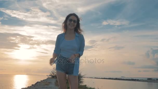 Junges schönes Mädchen rennt zum Sonnenuntergang, über die Schulter geschossen, Steadicam-Schuss — Stockvideo