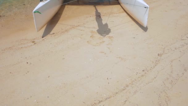 Segelbåt, katamaran, på tropisk strand med blå vatten — Stockvideo