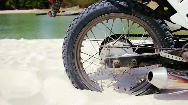 Wheel of motocross bike starting to spin and kicking up ground and sand — Stock Video