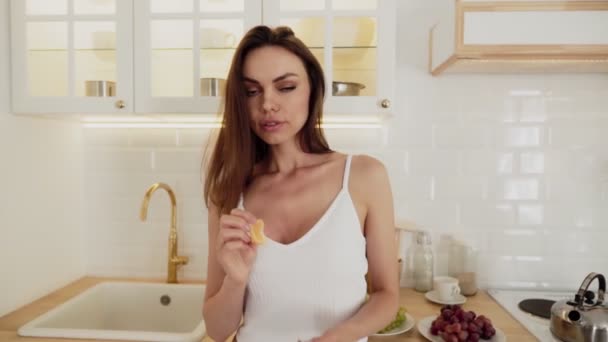 Beautiful sexy woman in white lingerie eat oranges — Stock Video