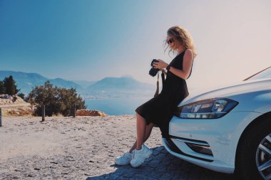 Arabasının yanında DSR kamerasıyla gezgin fotoğrafçı.
