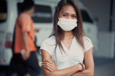 young beautiful Asian woman or hospital nurse using protective medical face mask