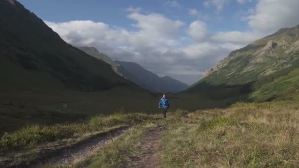 Férfi hátizsákos sétál a hegyekben — Stock videók