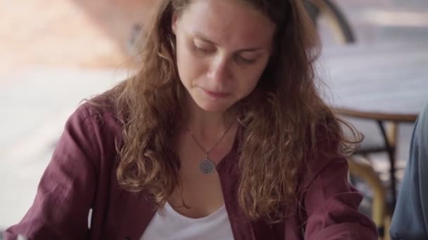 closeup of Happy female friends working together with laptop at outdoor cafe
