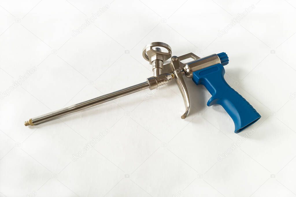 Instrument for construction foam on white background.Gun from become for construction industry