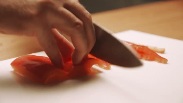 Cook hands cut into red peppers on a cutting board. The concept of a healthy — Stock Video