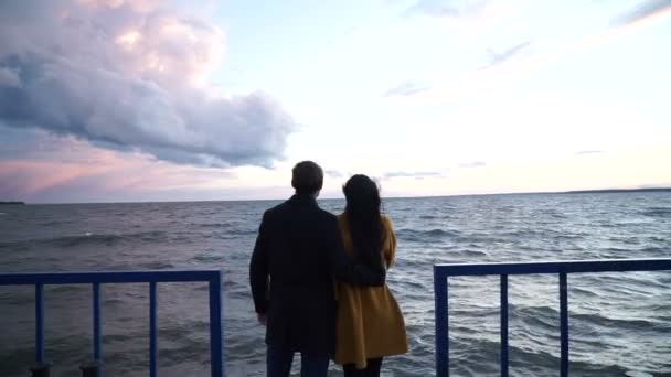 Man shows his girl beautiful landscape, couple spends time on pier — Stock Video