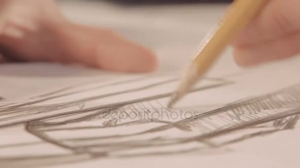 As mãos desenham com um lápis. O designer traça uma linha no papel. Close-up — Vídeo de Stock