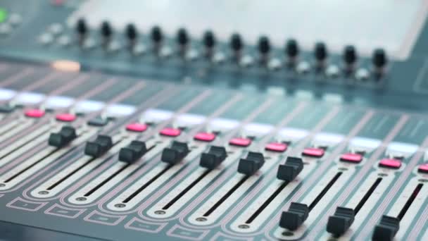 Digital audio workstation with an audio console. Soundboard knobs. Close up. DOF — Stock Video