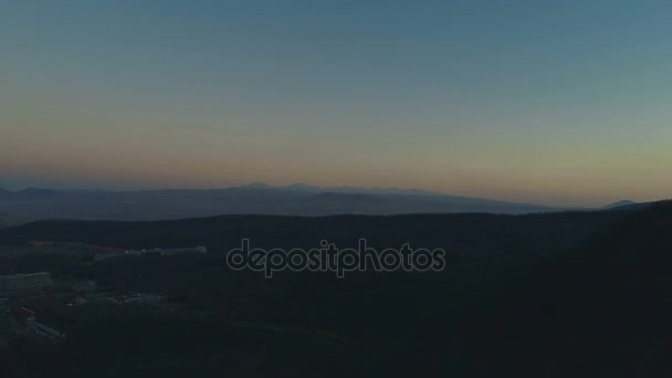 Top view of sunset above green forest and mountain — Stock Video