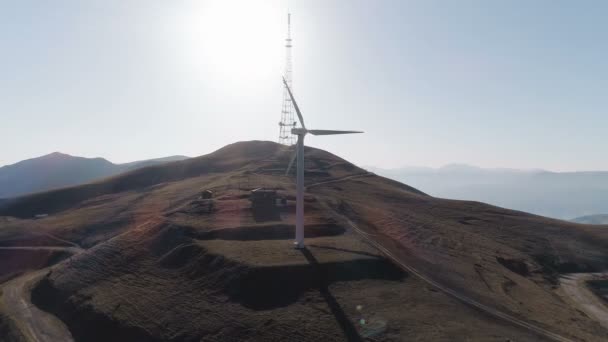 Wind turbines create renewable energy Cooling tower of power plant in background — Stock Video