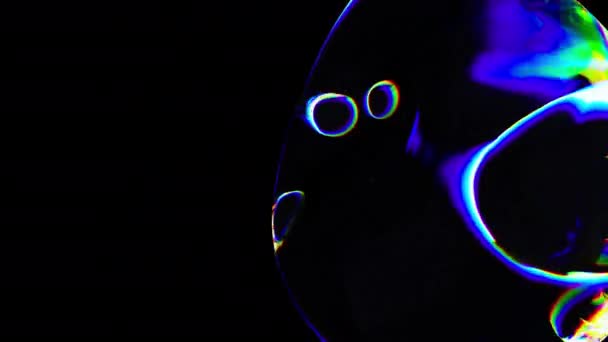 Transparante veelkleurige glazen bubbels in de donkere ruimte — Stockvideo