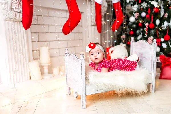 Cute baby on a little bed between lights — Stock Photo, Image