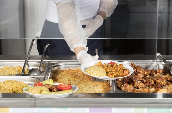 Chef standing behind full lunch service station — Stock Photo, Image