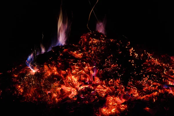 Una foto de baja luz de larga exposición de carbones ardientes . — Foto de Stock