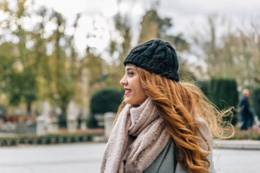 Profile view of a beautiful blonde girl smiling in the middle of