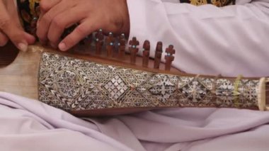 ISLAMABAD, PAKISTAN - 25 Aralık 2016 - Pakistan 'ın İslamabad kentinde düzenlenen Yıllık Şafak Medya Festivali öncesinde enstrümanı akort eden geleneksel Rubab çalıcısı.
