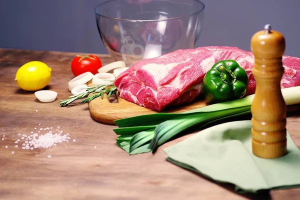 Vers vlees op de tabel en andere ingrediënten voor het koken — Stockfoto