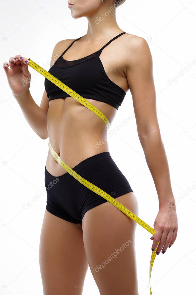 Measuring the parameters of the figure, the girl on a white background in lingerie