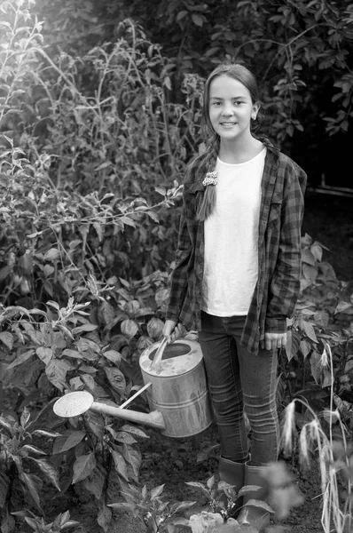 Black and white image of happy young girl in red rubber boots wa — Stock Photo, Image