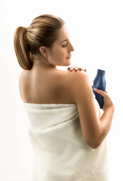 Portrait of brunette woman using creme after shower — Stock Photo, Image