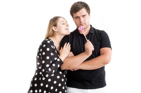 Funny portrait of young couple posing with lollipop — Stock Photo, Image
