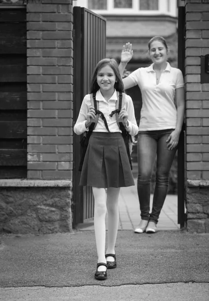 Black and white image of beautiful smiling girl in schoolgirl st — Stock Photo, Image