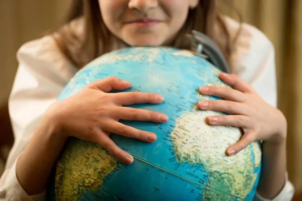 Closeup image of cute girl holding hands on globe. Concept of Ea — Stock Photo, Image