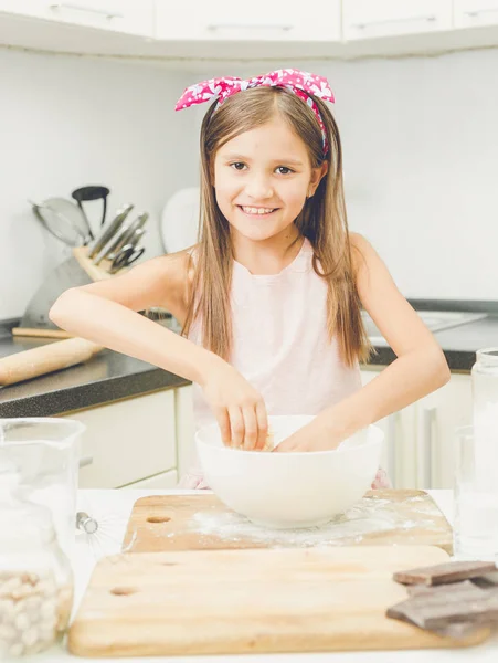 Portrait of beautiful smiling girl making dough for pie in white — Stock Photo, Image
