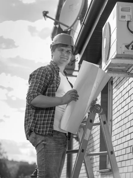 Black and white image of young male technician checking air cond — Stock Photo, Image