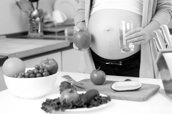 Primer plano en blanco y negro de la mujer embarazada posando en kitche — Foto de Stock