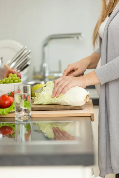 Closeup image of woman cutting fresh cabbage for soup — Stock Photo, Image