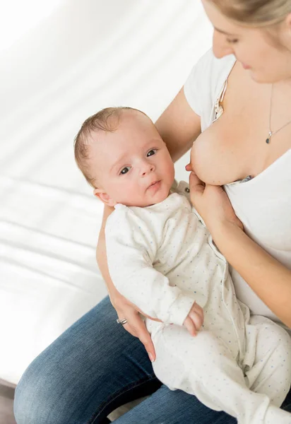 Junge Mutter stillt ihr 3 Monate altes Baby auf dem Bett — Stockfoto