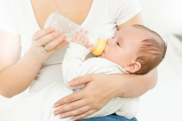 Retrato de la madre dando leche del biberón a su bebé — Foto de Stock