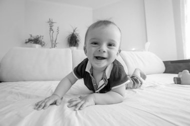 Siyah beyaz portre üzerinde sürünerek gülümseyen bebek olmak