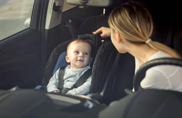 Retrato de la madre y el bebé sentado en el coche en los asientos delanteros —  Fotos de Stock