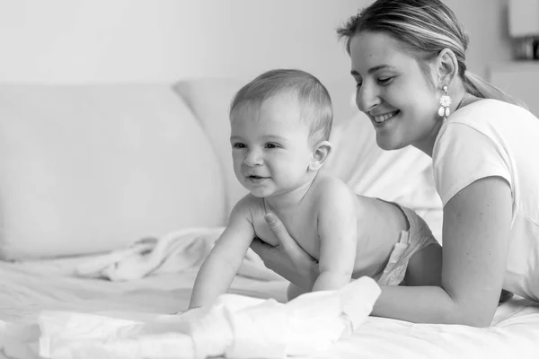 Black and white portrait of happy smiling baby siting with his m — Stock Photo, Image