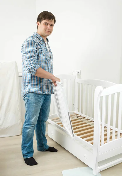 Young handsome man assembling furniture — Stock Photo, Image